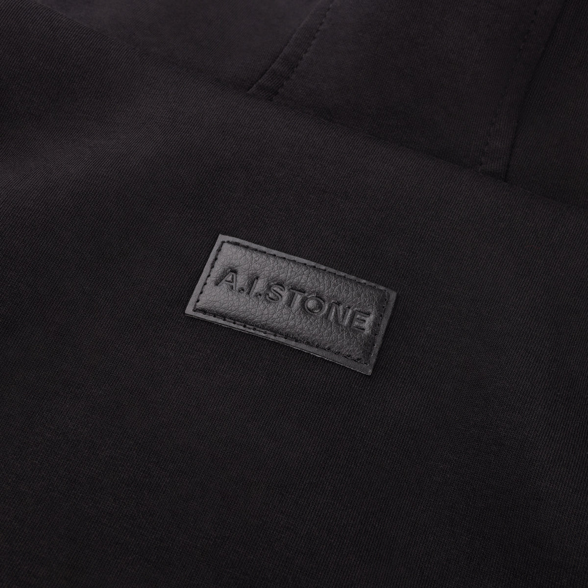 A.I.STONE logo patch on the back of the HALO Hoodie, below the hood